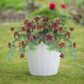 Plastic artificial flower container with 12 ground forks in courtyard garden setting