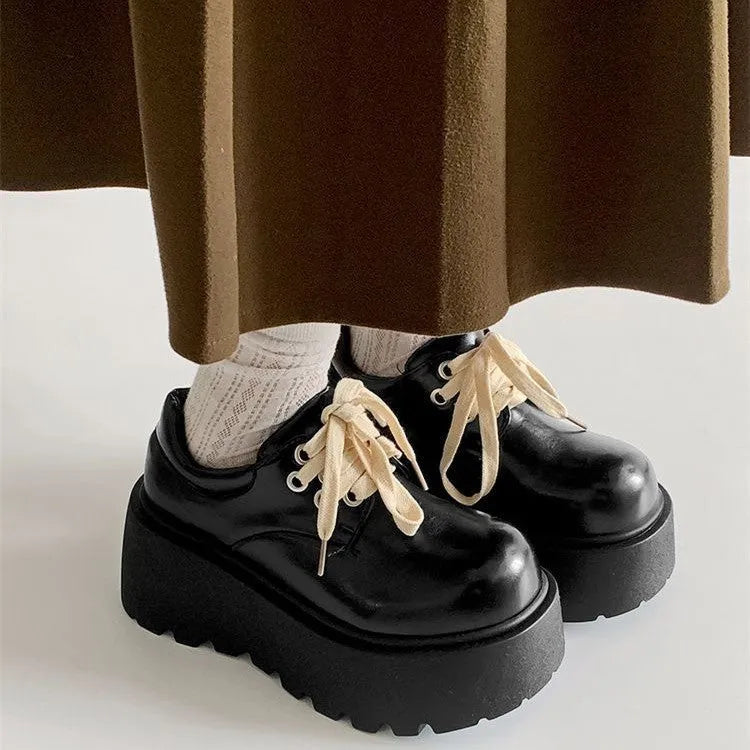Women's black matte PU leather chunky platform shoes with lace-up buckle and round toe.
