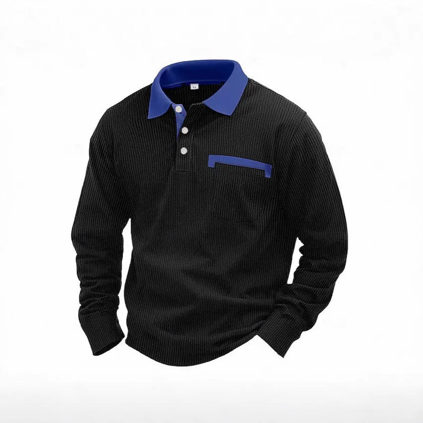 Man wearing a long-sleeved waffle knit polo shirt with an asymmetric collar in a dark colour.