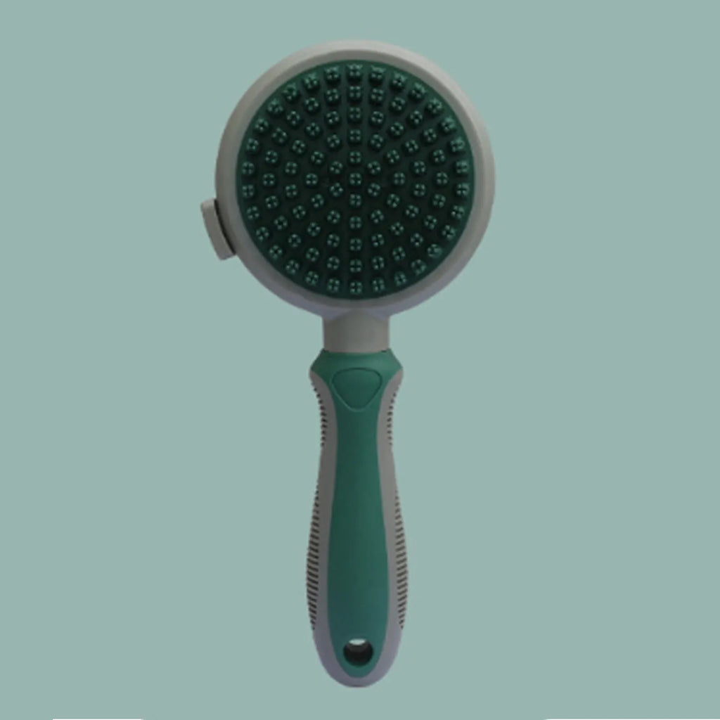 Pink double-sided cat grooming brush with release button and separate flea comb on white background