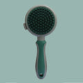 Pink double-sided cat grooming brush with release button and separate flea comb on white background