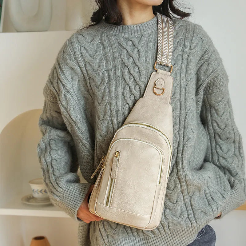 Soft brown PU leather women's crossbody chest bag with open front pocket.