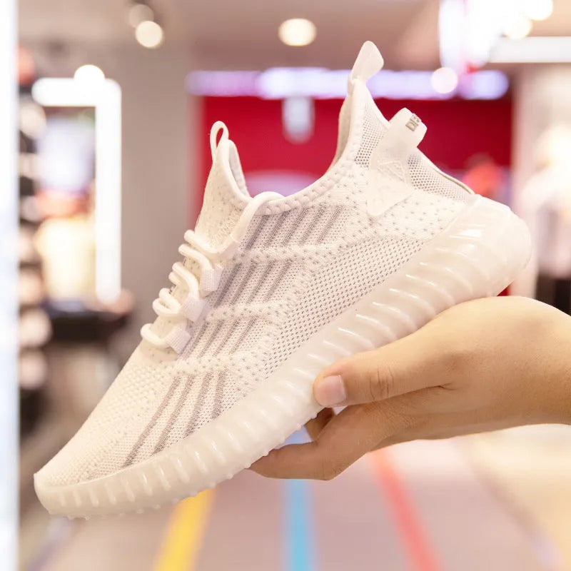 Men's white flying fabric breathable sneakers with mesh lining, round toe and low upper design on a neutral background.