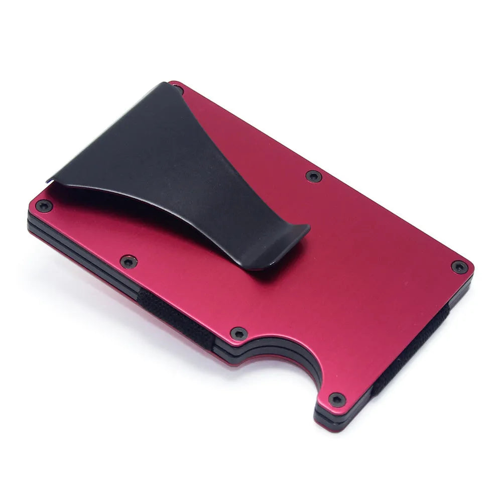Slim black carbon fibre card holder wallet with geometric design on a desk.