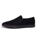 A pair of low-top canvas slip-on sneakers with a round toe and vulcanised rubber sole on a neutral background.