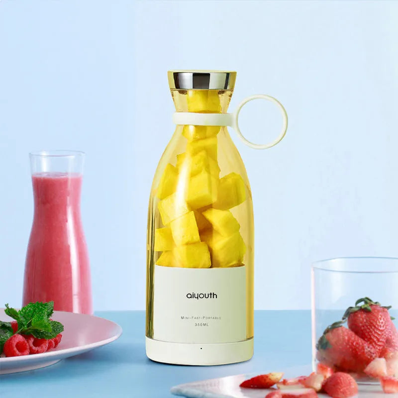 Handheld portable mini juicer in pink with USB charging cable and four-blade stainless steel cutter