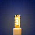 Small white USB-powered LED night light showing warm and white light options on a table.