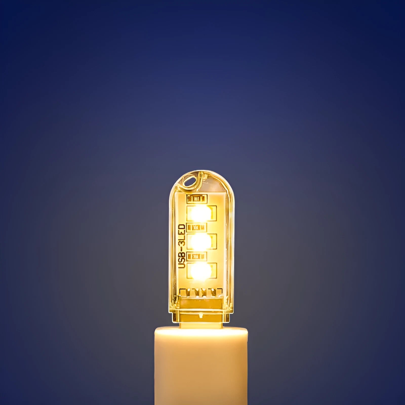 Small white USB-powered LED night light showing warm and white light options on a table.