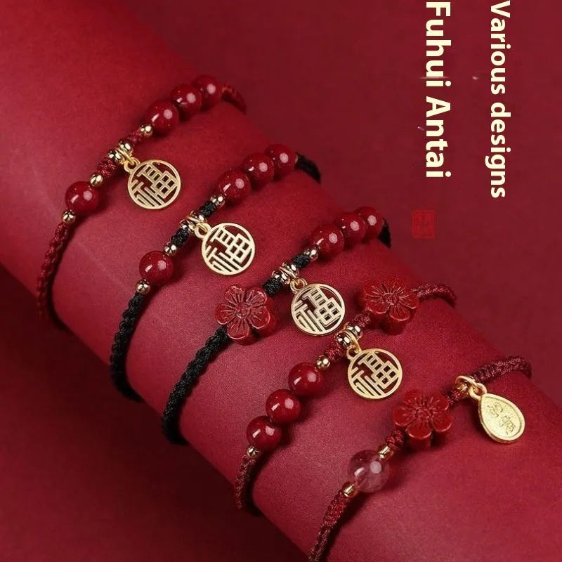 Cinnabar bracelet with braided rope in three colour options featuring round bead or flower blessing card charms