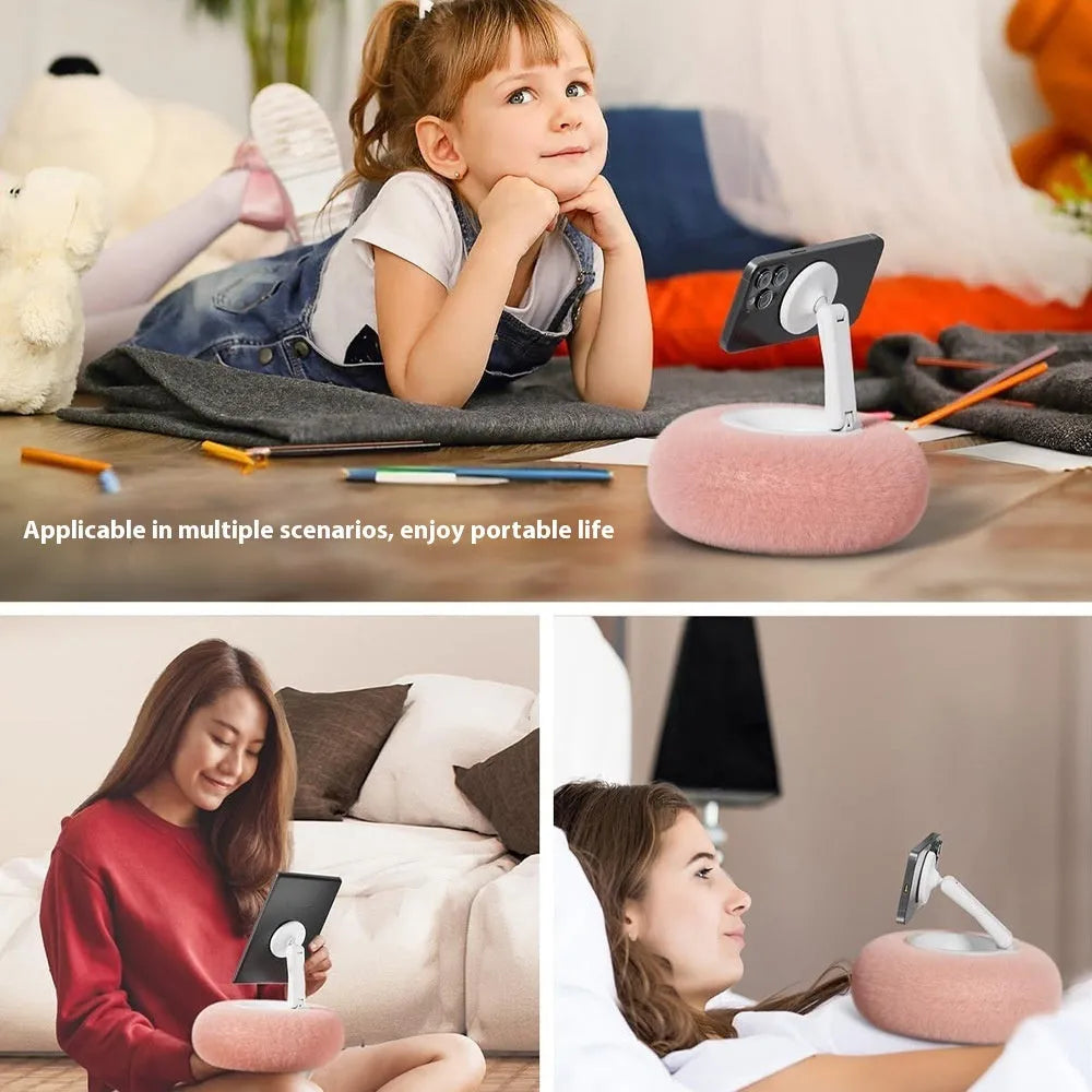 Magnetic mobile phone pillow bracket stand in pink, creamy-white, and khaki green on a bedside table