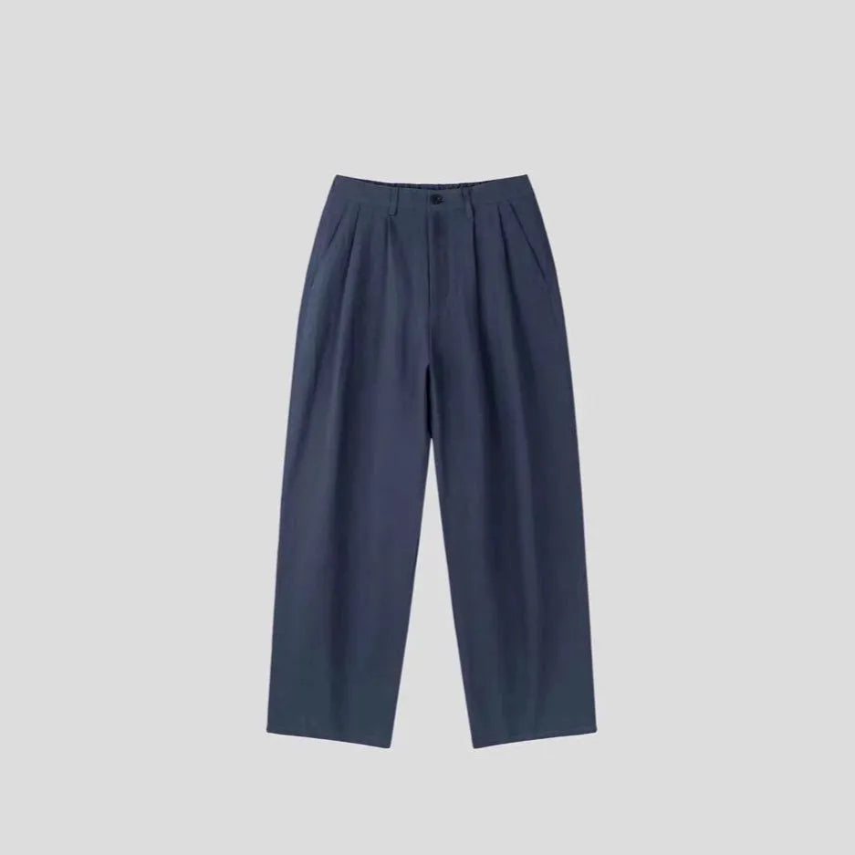 Men's apricot wide-leg cotton linen trousers with a loose fit and pencil leg opening.