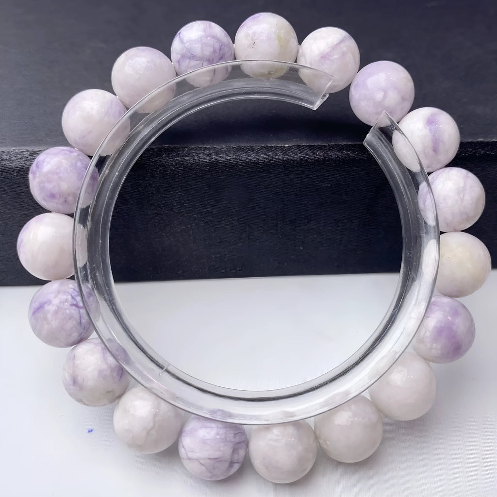 A purple turquoise bead bracelet for women showing round stone beads on a wrist.