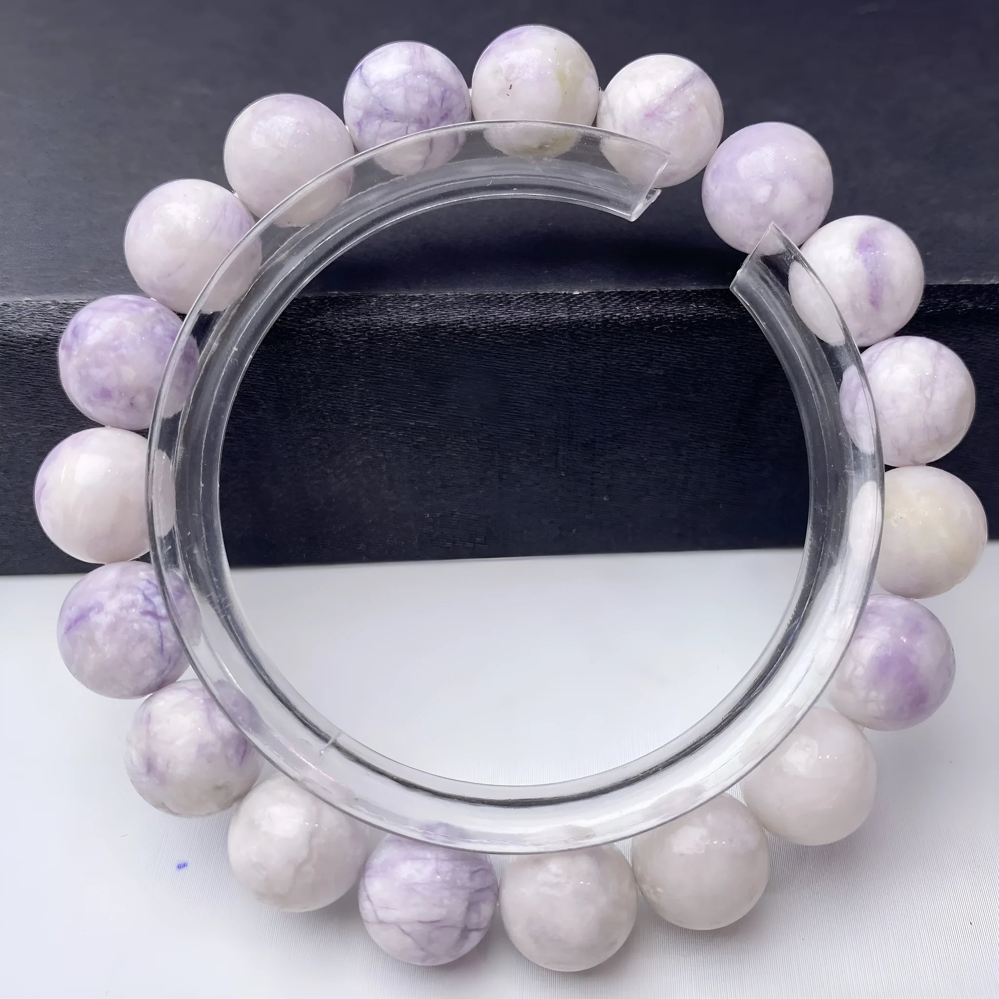 A purple turquoise bead bracelet for women showing round stone beads on a wrist.