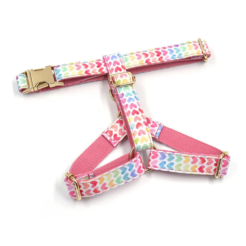 Pink colourful dog harness with heart-shaped stones and gold buckle fastenings on chest and back support design