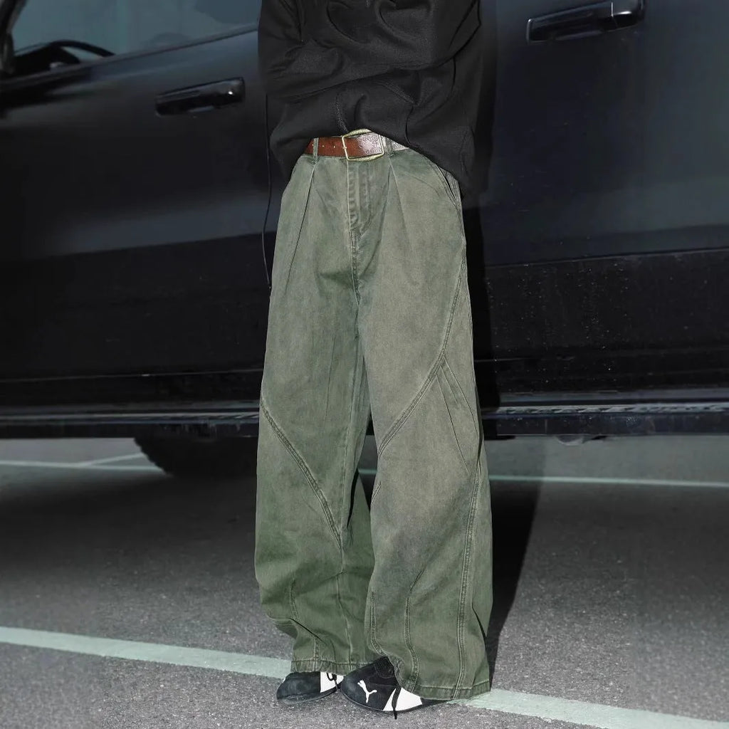 Men's pleated straight-leg trousers in a striped pattern, showing loose fit and straight hem.