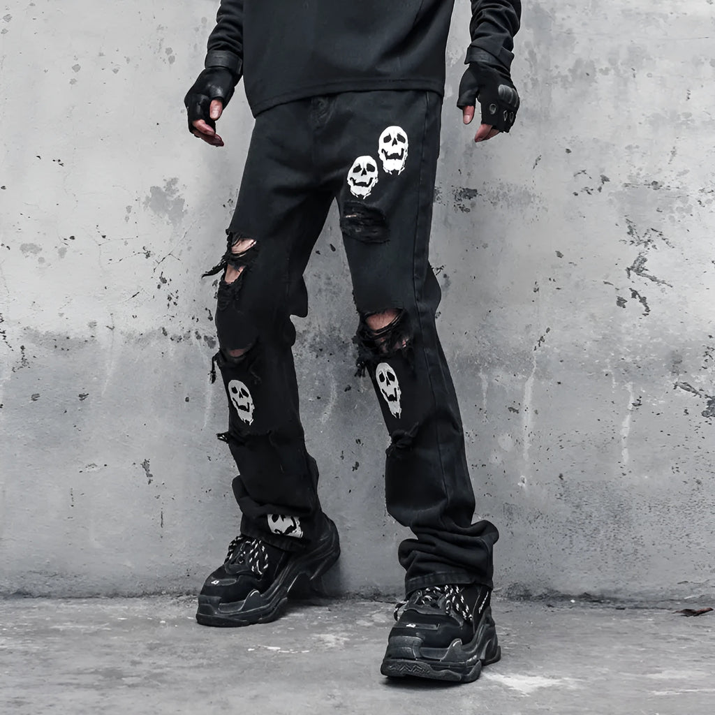 Black cotton denim jeans with skull and crossbones distressed design, mid waist, fit flared horn trousers for men.