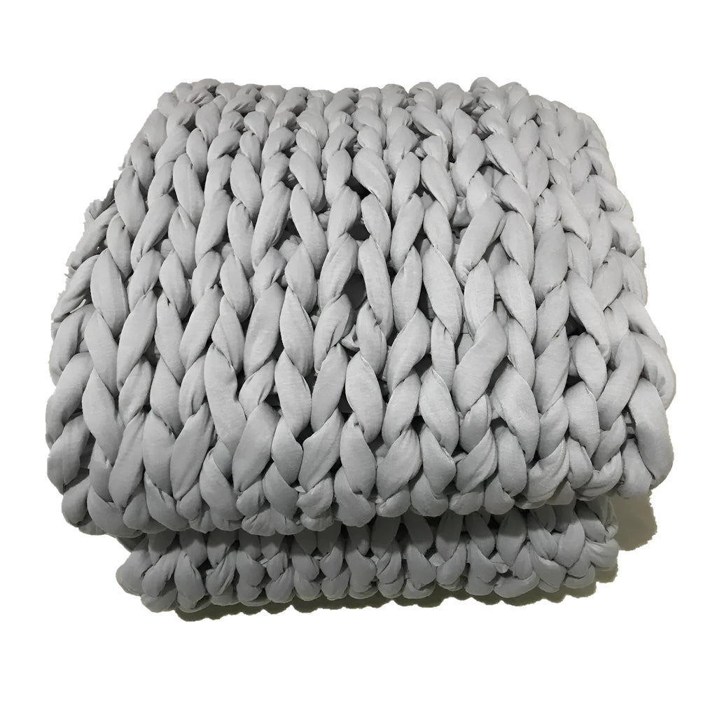 Hand-woven chenille polyester weighted blanket in beige solid colour, 200x200cm size on a bed.