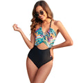 Women's black one-piece swimsuit with a colourful patchwork leaf print design.