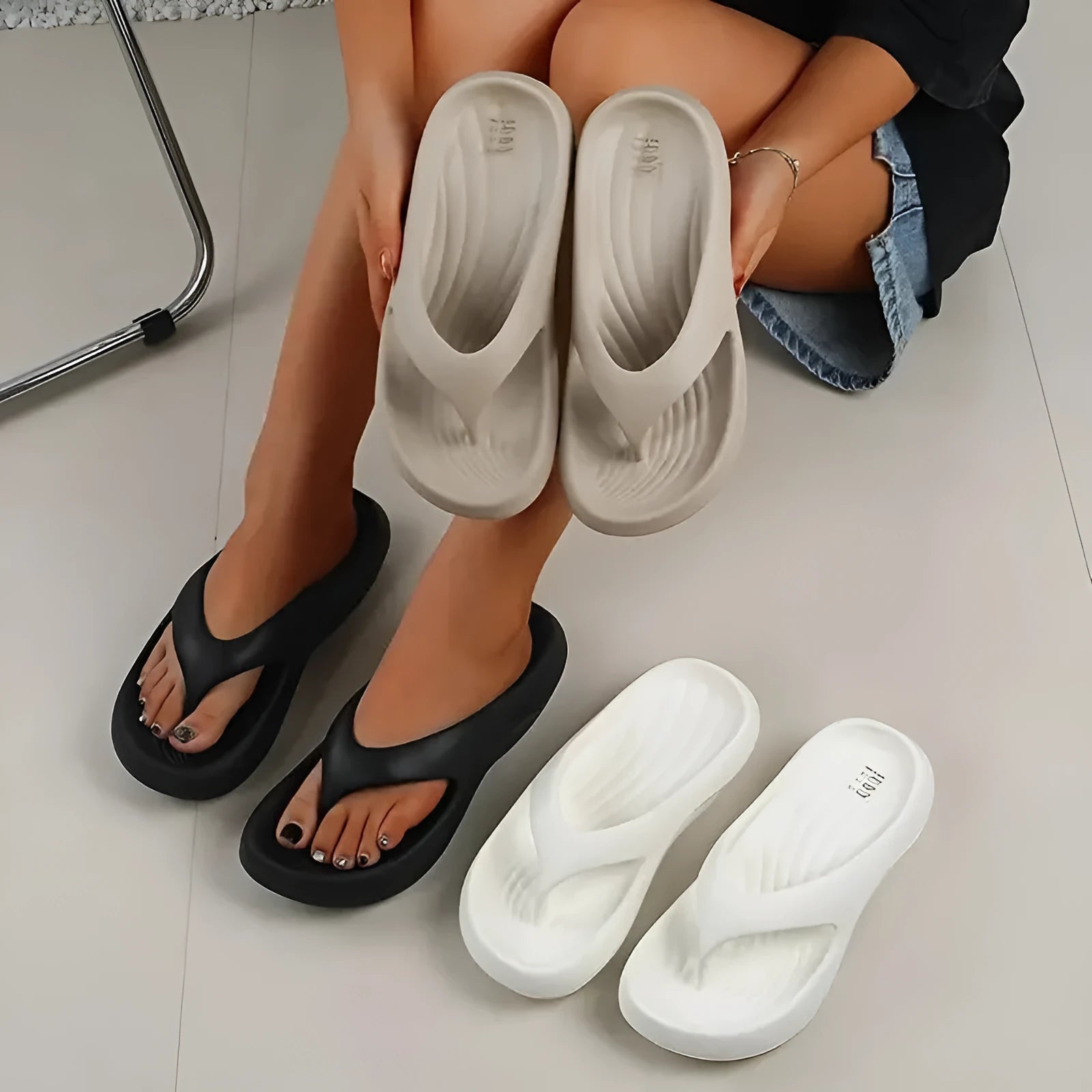 Women's black EVA flip flops with thick sole and textured footbed, shown from above.