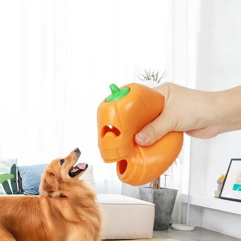 Orange Halloween pumpkin shaped interactive dog chew toy with a treat-dispensing funnel.