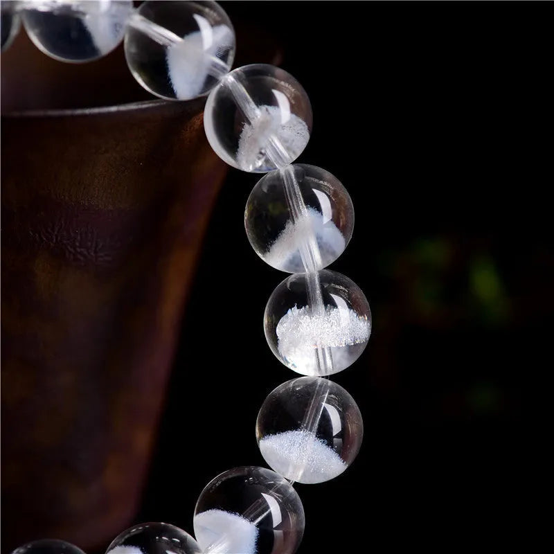 Women's white crystal bracelet with natural ghost pyramid shapes and Ruyi design elements