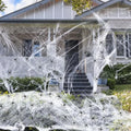 Cotton spider web Halloween decoration set with artificial spiders on dark background