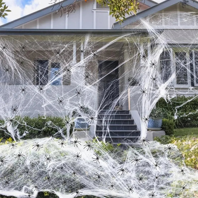 Cotton spider web Halloween decoration set with artificial spiders on dark background