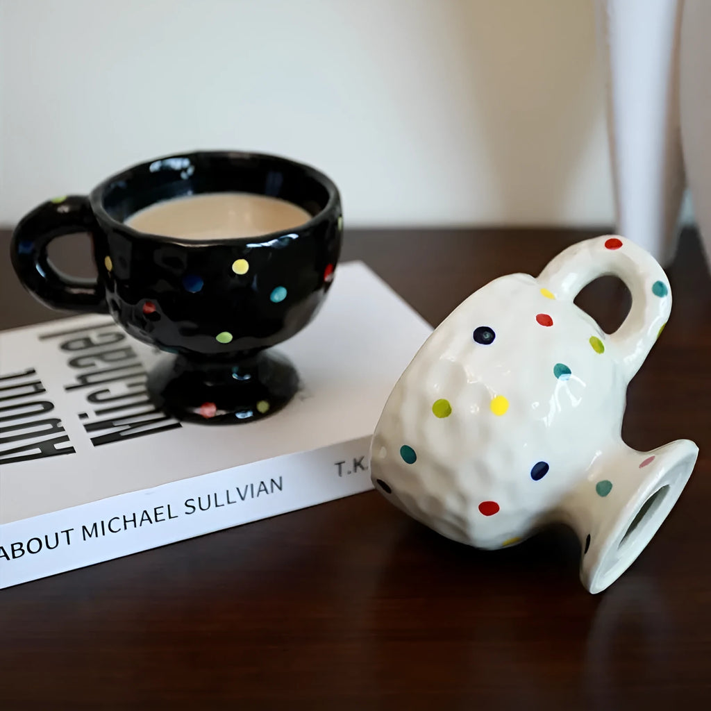 Hand-pinched irregular ceramic mug in a solid colour, showing its unique shape.