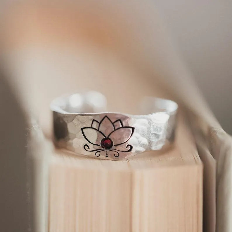 Silver alloy electroplated lotus ring on a light background, glossy finish, minimalist design