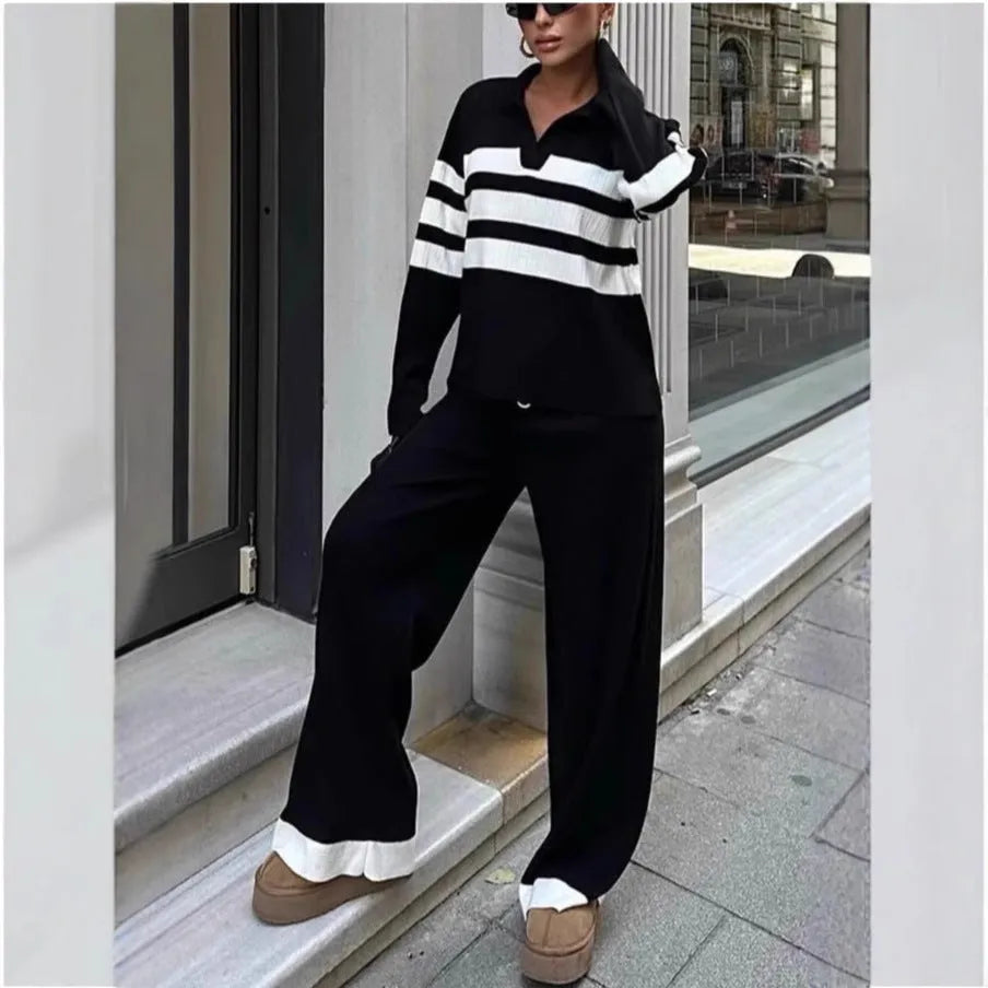 Women's black and white striped knitted top with polo collar and matching trousers casual set.
