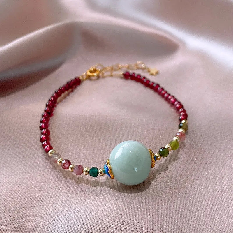 Women's Chinese style bracelet with garnet colour, drop-shaped tourmaline stones and electroplated finish