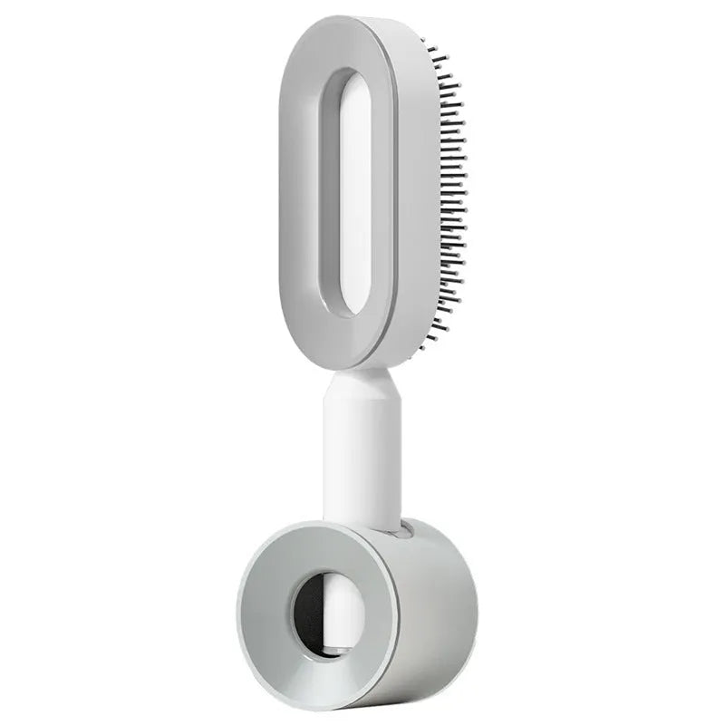 Self-cleaning air cushion hair brush in white, black gold, or black purple with ergonomic handle