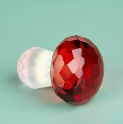 Colourful crystal mushroom decorative ornament in modern geometric style on a plain background.