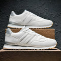 Men's black sports casual shoes with a carved wing pattern on the leather upper and a round toe.