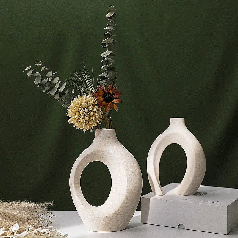 Two European ceramic vases with glazed snuggle colour finish, set on a shelf for creative home decoration
