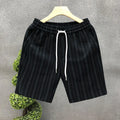 Men's black and white striped fleece-lined casual shorts on a neutral background.