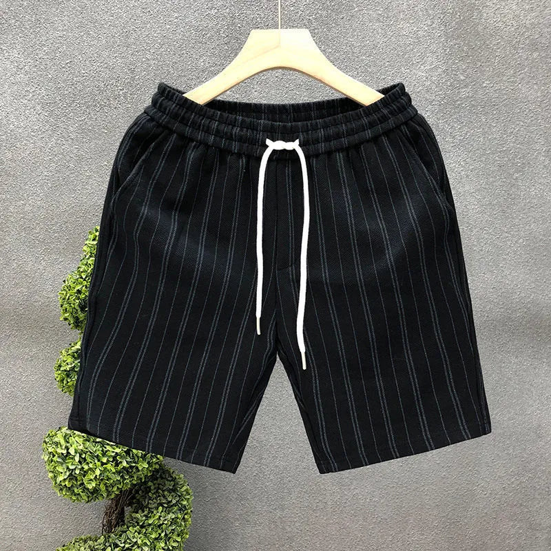 Men's black and white striped fleece-lined casual shorts on a neutral background.