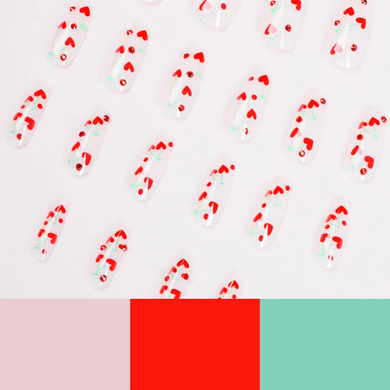 Pack of 24 red French love themed nail art stickers with small cherry and diamond designs, includes glue.