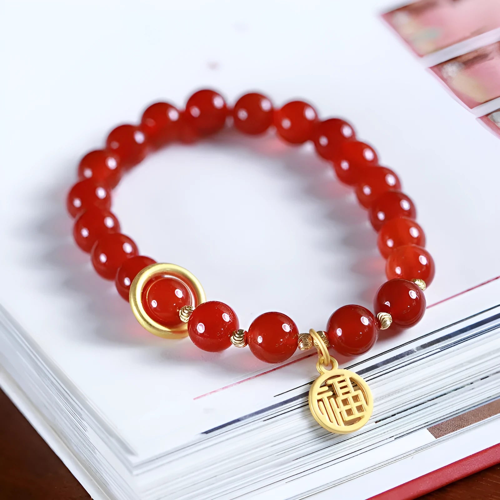 Natural red agate bead bracelet with woven design and blessing card on a neutral background.
