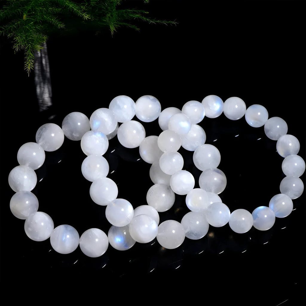 Natural blue moonstone round beads strung on a white cord bracelet.