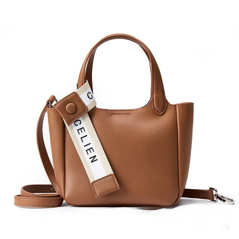 Brown cattlehide leather cross body bucket bag with square vertical design and slit pocket