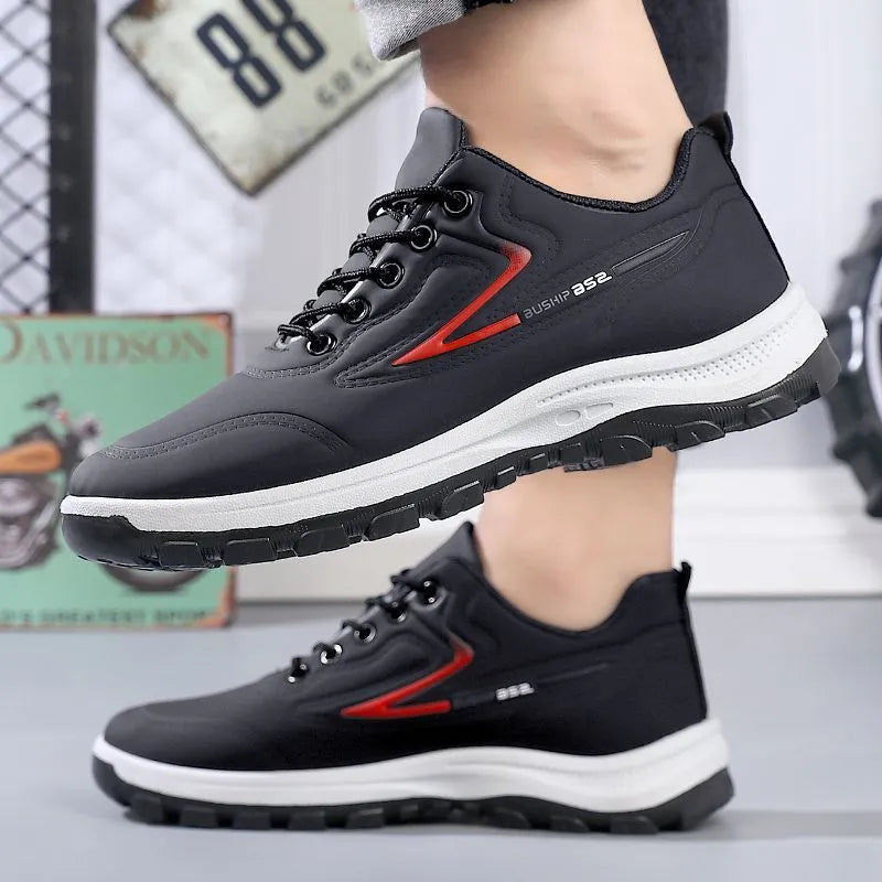 Black and grey low-top waterproof casual shoes with a lace-up front and plastic sole.