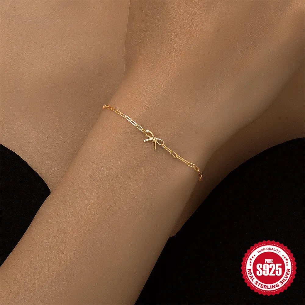 Gold tone S925 sterling silver bracelet with heart charm and clip chain closure
