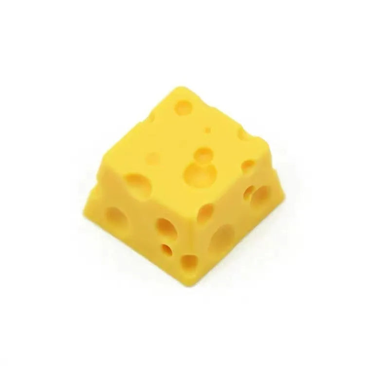 Close-up of a bright yellow resin key cap with a detailed sculpted cheese design.