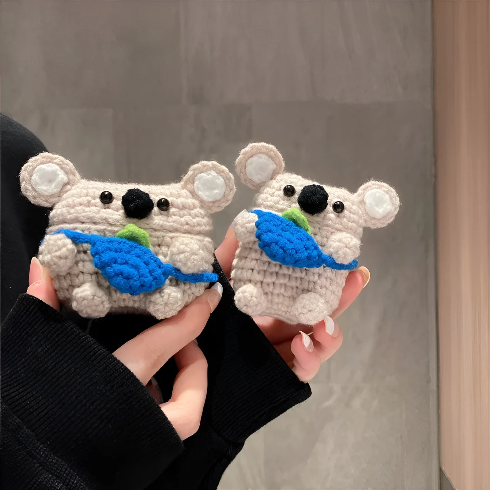 Hand-knitted koala bear backpack design cover for Apple AirPods case.