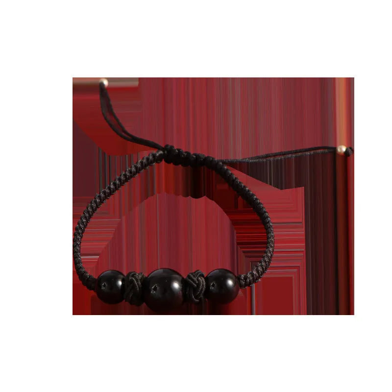 Woven red rope bracelet with spherical strawberry quartz beads and alloy clasp