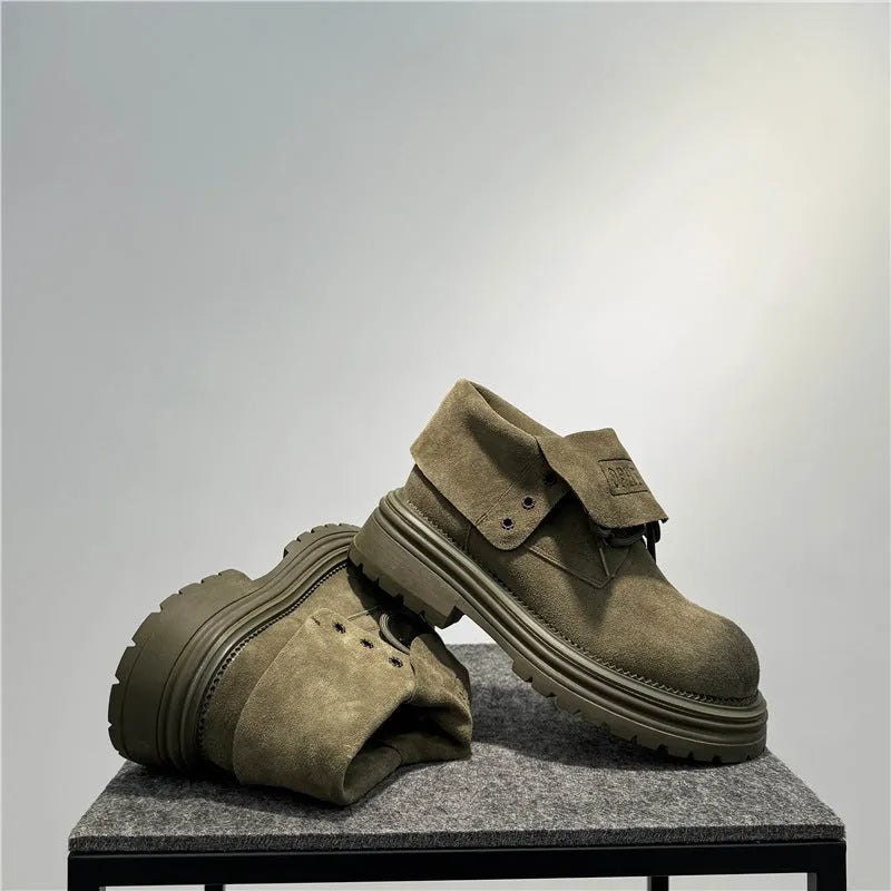 Retro distressed worker boots in cow suede with thick soles and low tube design.