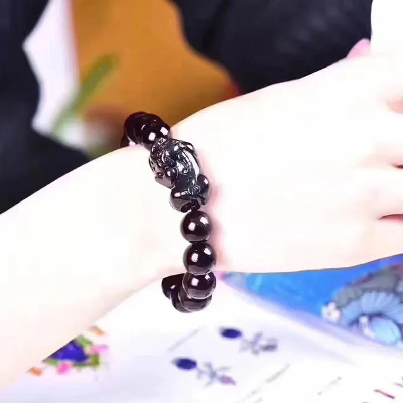 Natural Ice Colour Eye Obsidian crystal bracelet with round beads on an adjustable cord.