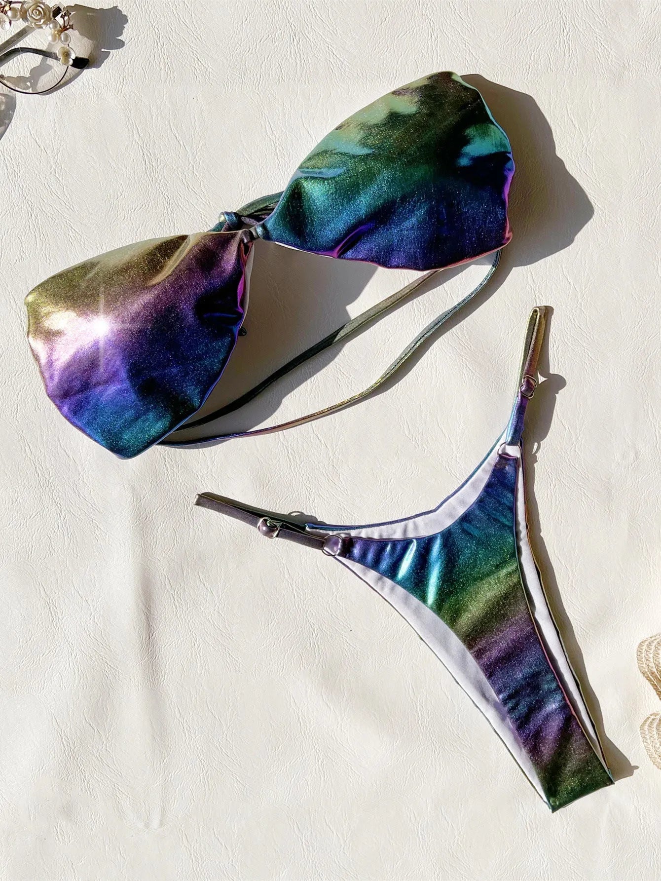 Women's gradient purple bikini swimsuit laid flat, showing top and bottom.