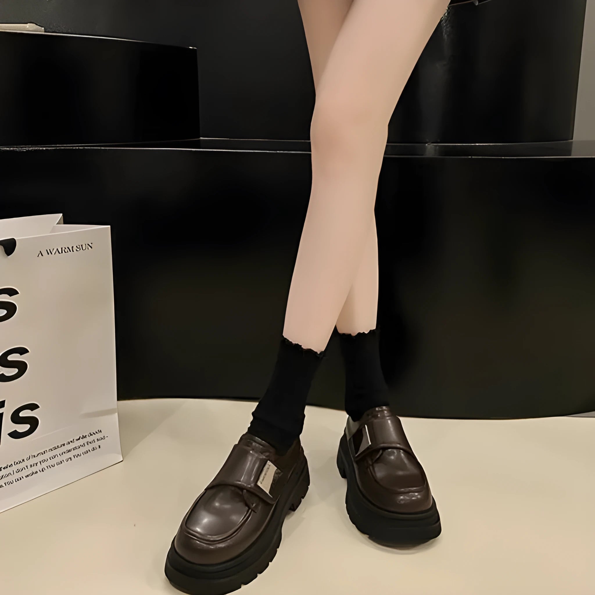 Women's black chunky heel shoes with low top, round toe, and cross strap detail on a white background